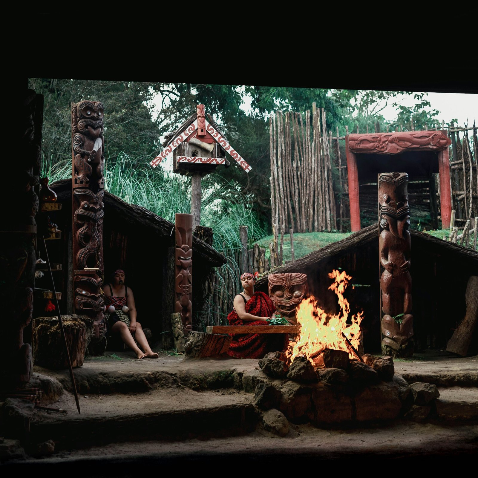 a group of people sitting around a fire pit